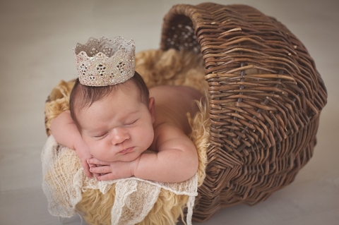 newborn girl with crown photo