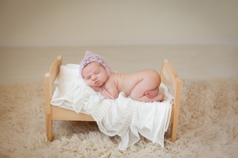 newborn baby girl on a wooden bed photo